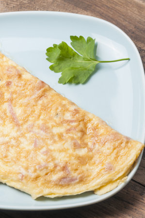 A delicious omelet with ham and cheeseの写真素材