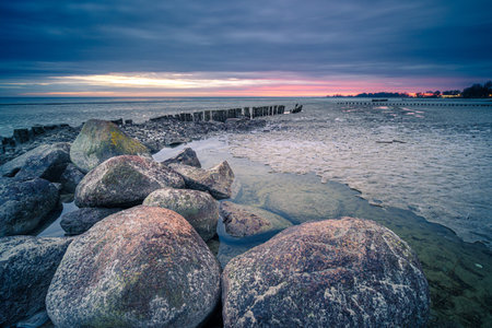 A mesmerizing view of a beautiful rocky seashore at scenic sunset