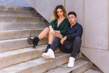 A loving couple in a romantic posing on the stairsの写真素材