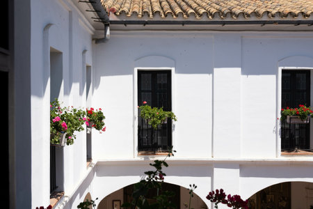 The white building with decorative flowers on windowsills of La Rabida Monastery in Huelvaの写真素材