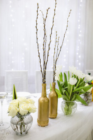 A vertical shot of decorative plants and flowers on the tableの写真素材