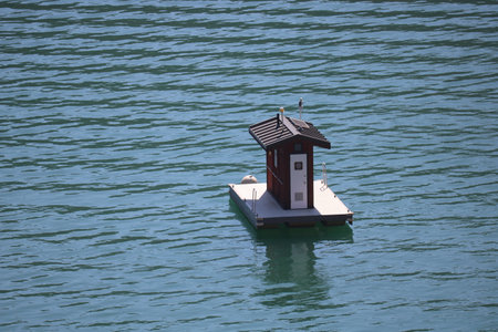A floating boat bathroom on the calm water of the seaの写真素材