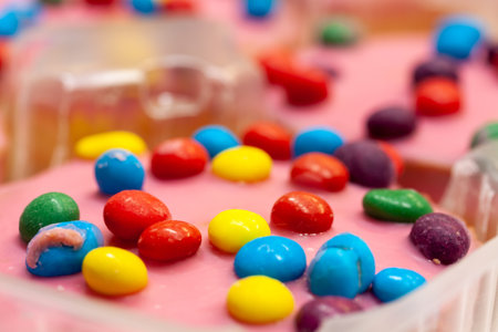 A closeup shot of homemade chocolate cookies decorated with multi-colored candies