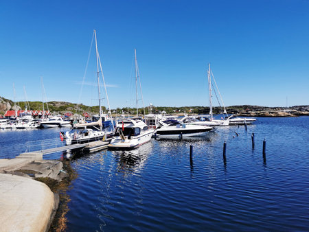 A scenic shot of a sea and a seaport full of boats in Verdens Ende, Norway