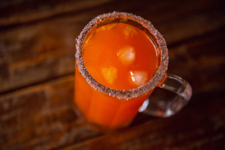 A top view of a fresh Mexican spicy Michelada drink in a salt-rimmed glassの写真素材