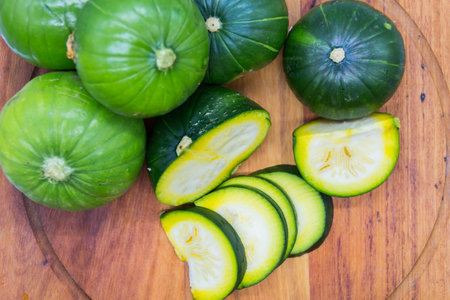 green log zucchini, cucurbita maxima on the wooden board, for cookingの写真素材