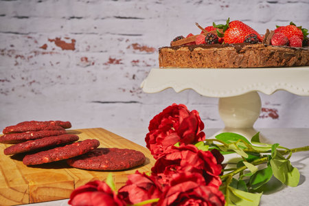 A brownie cake and red velvet cookies with roses to celebrate mother's dayの写真素材