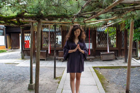 A young Caucasian female doing a meditation pose outdoorsの写真素材