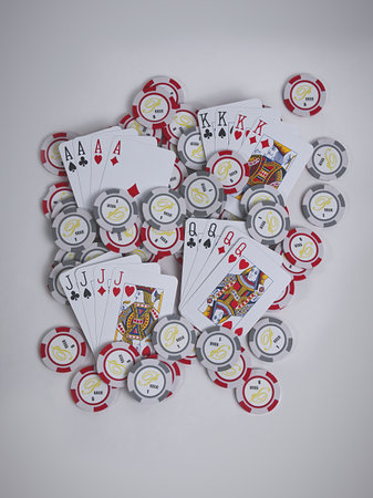 A top view of poker cards and chips on a white background