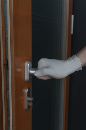 Opening doors with gloves during the Coronavirus crisisの写真素材
