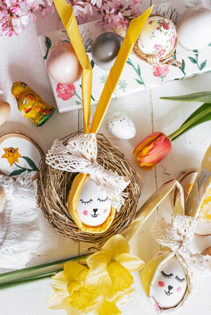 Easter decorations on white wooden background. Flowers, easter eggs, spring, holiday, celebration,...