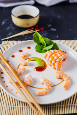 A high-angle shot of delicious Japanese shrimps with wasabi with soy sauce on the tableの写真素材