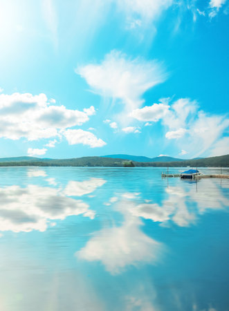 wilderness lake and sky reflected in the waterの写真素材