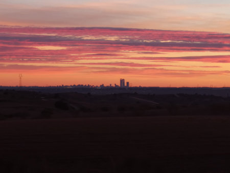 A beautiful view of the city buildings and an orange sunsetの写真素材