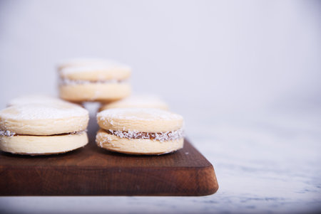 Homemade caramel cookies, decorated with pieces of coconut, confectionery sugar and caramel spread.の写真素材