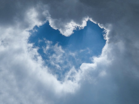 A beautiful hole in the clouds in the shape of a heart; love and romanceの写真素材