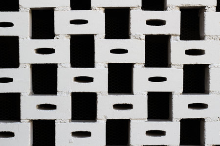 A closeup shot of a white brick wall against a black background