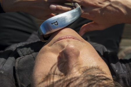 Golfer Holding Her Golf Club in Front of Her Face in Switzerland.の写真素材
