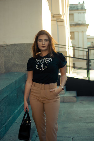 A closeup shot of a caucasian female with beautiful clothes posing outdoorsの写真素材