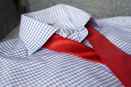 A male checkered shirt with a red tieの写真素材