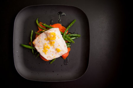 grilled halibut with lemon zest and fresh vegetablesの写真素材