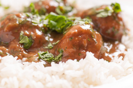 honey garlic meatballs with vegetables and white riceの写真素材