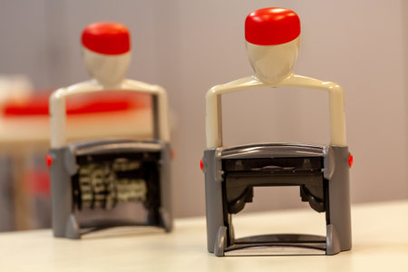 Two rubber stamp on a white surfaceの写真素材