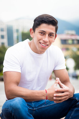 A vertical shot of an attractive Colombian guy on a gloomy day outdoorsの写真素材