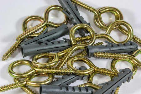 A closeup shot of golden hinge and dowel screws