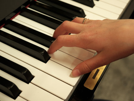 Photo taken while the child is practicing the piano at home.の写真素材