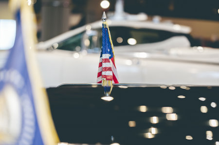 The US flag on an old vintage shiny carの写真素材