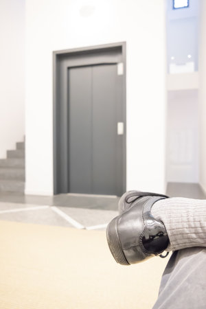 One Shoe in Front of and Elevator Door in Switzerland.の写真素材