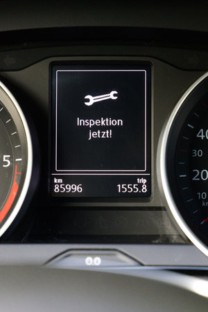 A vertical shot of a display in a car cockpit with service now text in German