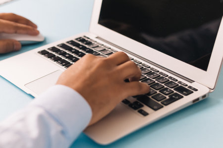 A closeup of a person working on his laptop - working from home