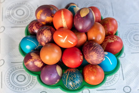 The traditionally homemade colorful Easter Eggs in a basketの写真素材
