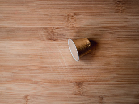 A top view of a coffee capsule for a machine on a wooden tableの写真素材