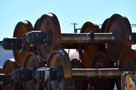 New train wheels being hauled on a train with metal chains in El Paso Texasの写真素材