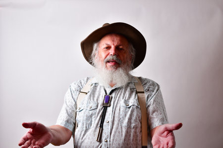 A senior Caucasian bearded male explaining a situation with both hands out on white backgroundの写真素材
