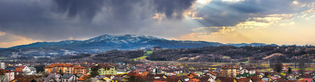 A panoramic shot of colorful buildings located on a mountainous area under the cloudy skyの写真素材