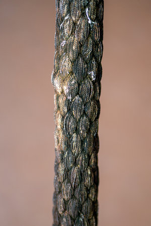 Close up details of a rope against brown background. Selective focus