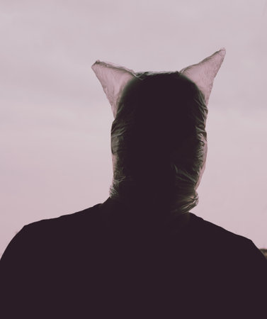 A closeup shot of a male with a transparent plastic bag over his headの写真素材