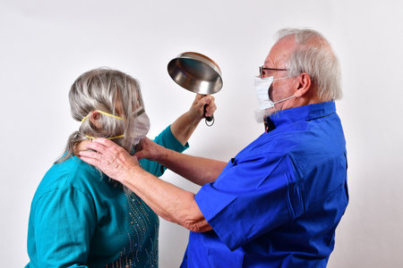 A senior couple with face masks fighting during quarantine