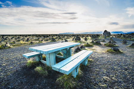 A closeup shot of a blue wooden bench and table in Lava natural spine Laufskalavarda, Icelandの写真素材
