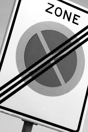 A black and white shot of the parking sign with the text of "zone"の写真素材