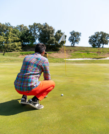 A young Caucasian male playing golf on a professional golf courseの写真素材