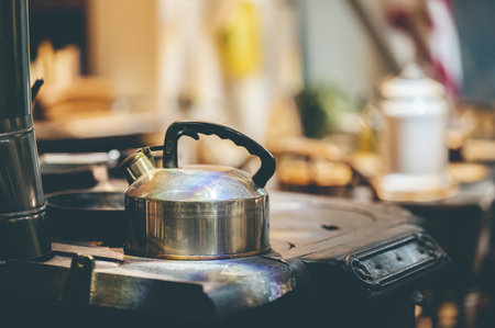 A stainless steel kettle on the stoveの写真素材