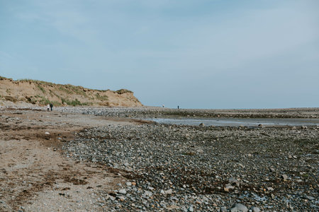 A beautiful shot of a rocky seashore under a bright skyの写真素材