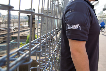 A closeup shot of a security guard in uniform patrolling at a stationの写真素材
