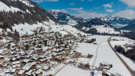 A beautiful aerial winter landscape of the snow-capped village of Rougemont, Switzerlandの写真素材