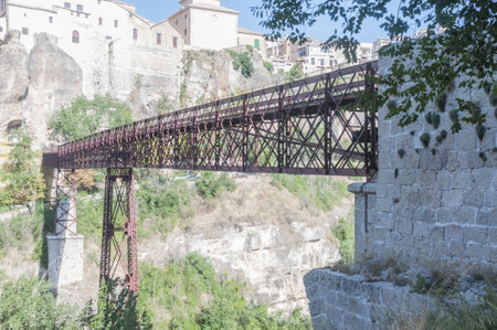 The Saint Paul Bridge surrounded by buildings in Cuenca, Spainの写真素材